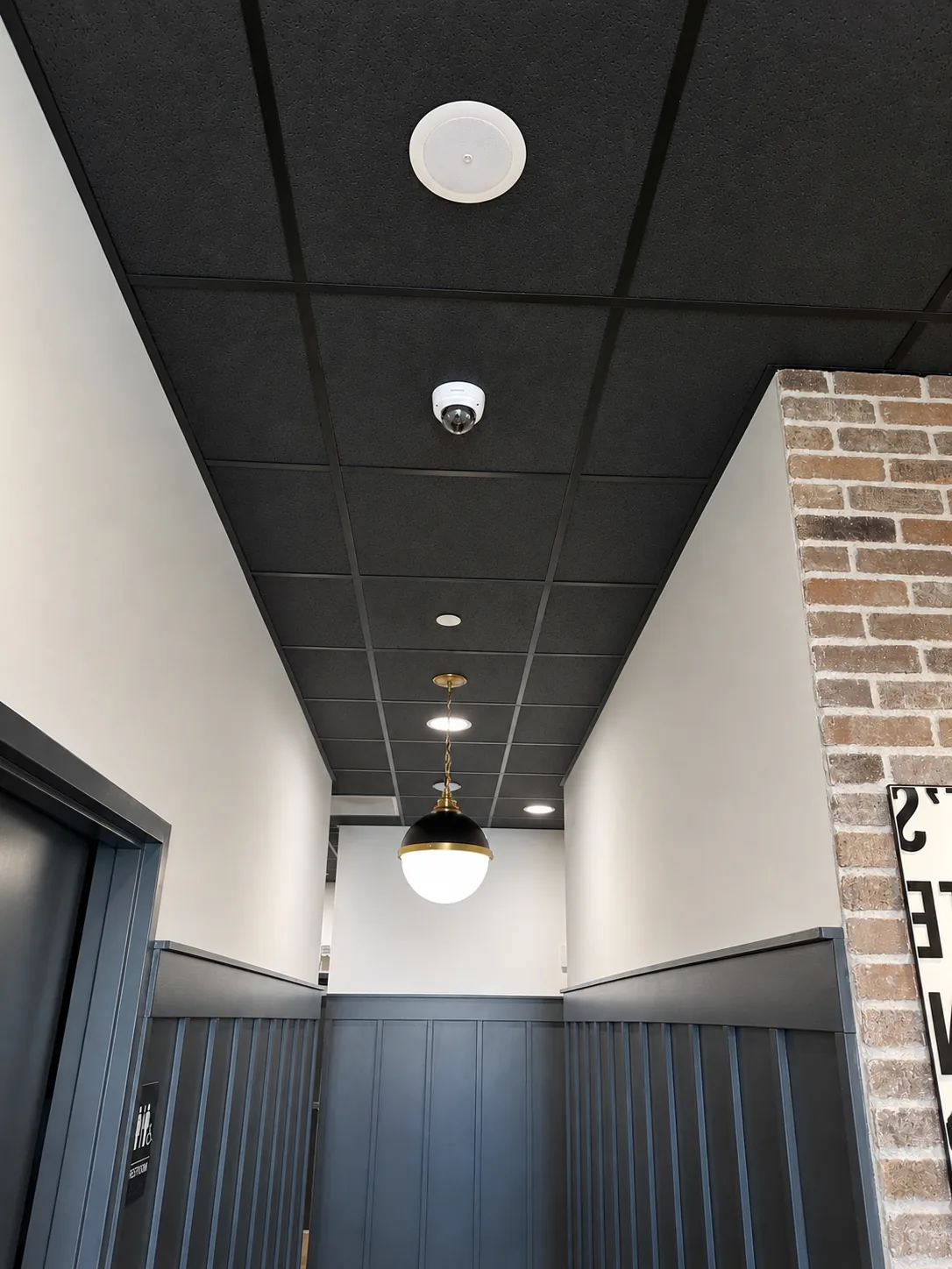 Ceiling-mounted security camera and distributed audio speaker at Call Orthodontics